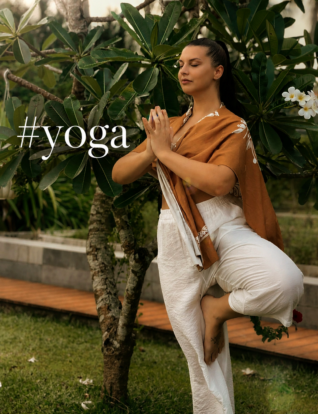 Yoga master in tree pose amid tropical greenery